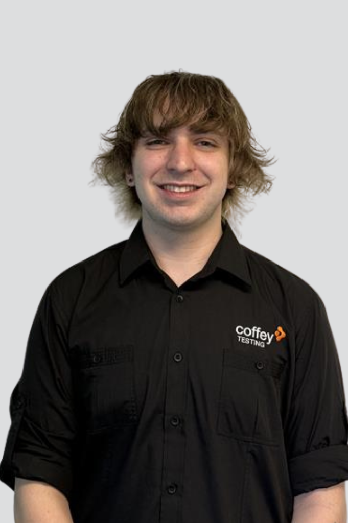 Flynn, HR Assistant at Coffey Testing, smiling in an office setting